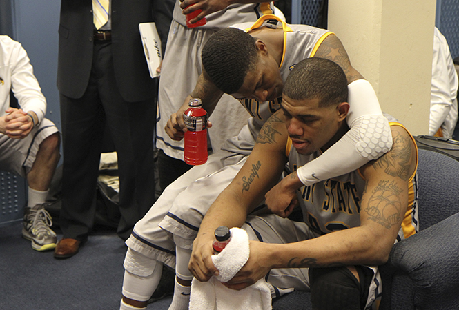 Junior guard Darren Goodson (right) and sophomore guard Kris Brewer (left) share a moment in the locker room after a 68-64 victory over Akron on Friday, March 8 at James A. Rhodes Arena. Goodson led the Flashes with 19 points and 8 rebounds, helping snap a five-game losing streak to the Zips. Photo by Shane Flanigan.