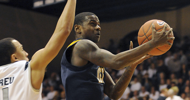 Senior guard Randal Holt drives the ball to the hoop, running around Akron's Alex Abreu and Quincy Diggs. Holt scored a total of 27 points in an 84-75 loss to the Zips on Jan. 21, 2012. Photo by Philip Botta.