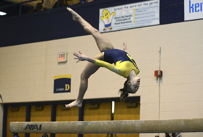 Freshman Nicolle Eastman performs on the barre at the first ever Beauty and the Beast competition on Feb. 8. The lady Flashes defeated Rutgers with a final score of 195.675-193.700. Photo by Jenna Watson.