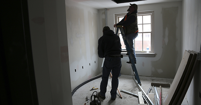 Construction workers work on the ceiling of the old Kent Hotel, which is now Acorn Corner, Feb. 2, 2013. The building is set to open on April 24 and will have a restaurant, offices and luxury apartments. Photo by BRIAN SMITH.