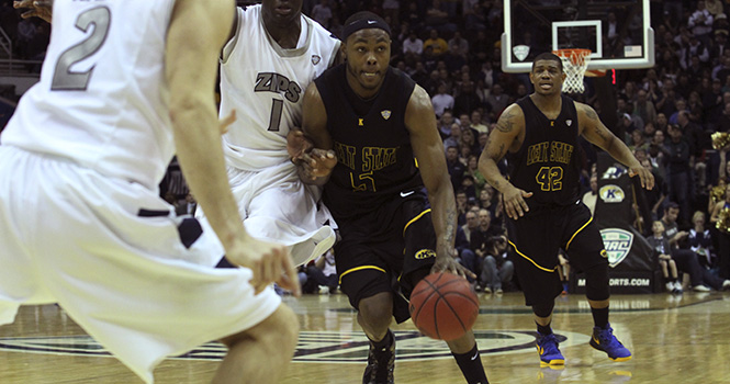 Senior forward Chris Evans makes his way down the court against junior forward Demetrius "Tree" Treadwell from the Akron at the MAC Tournament on Friday, March 15, 2013. The Flashes ended a 6-game winning streak falling to the Zips 59-62. Photo by Chelsae Ketchum