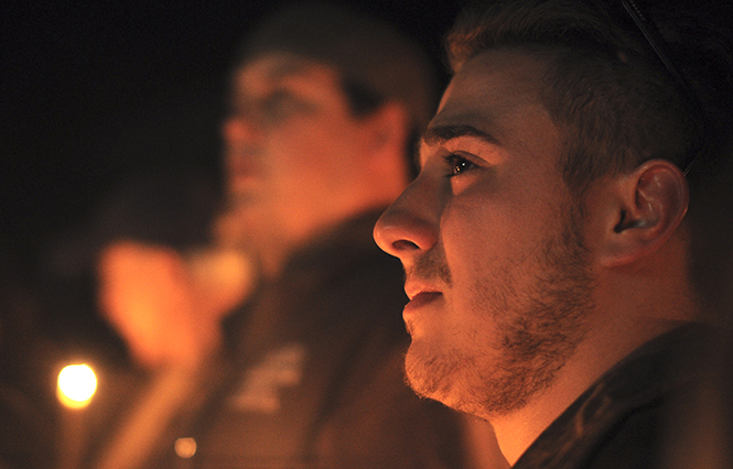 A friend of J.J. Marino expresses sorrow while listening to fellow friends give testimonies at the candlelight vigil held in Marino's honor on April 2, 2013 at his former residence. Photo by Jacob Byk.