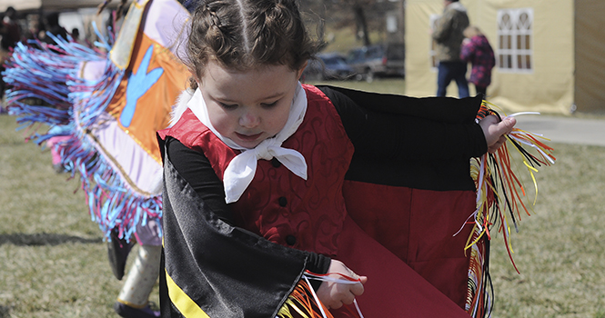 Pheonix Harper, 7, dances in outside the arena at the Powwow on campus through the Native American Student Association on Aoril 6, 2013. Photo by Jacob Byk.