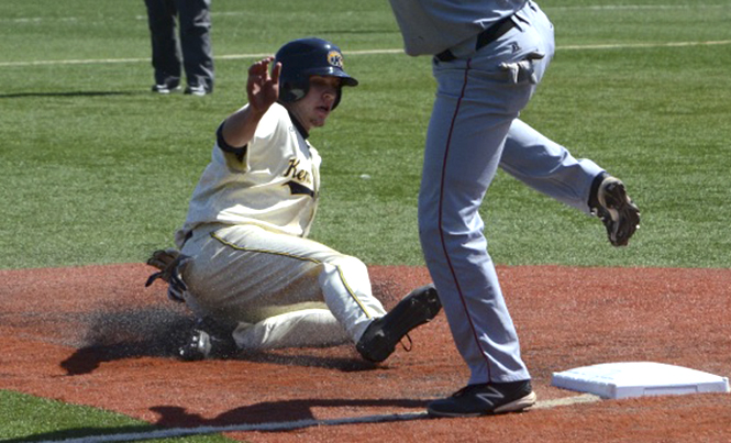 Freshman Zarley Zalewski slides into third base during Kent State's home game against Ball State on Saturday, March 30 at Schoonover Stadium. The Flashes won their first game with a final score of 11-5, but fell to Ball State in the second game, 4-3. Photo by Zane Lutz.