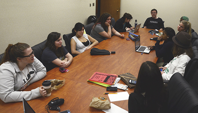 Members of the Kent State Invisible Children Organization discuss upcoming events on their agenda at the meeting on April 10. Events discussed included "Move Dance Party," which is took place at Bar 157 on April 12. . Photo by Zane Lutz.