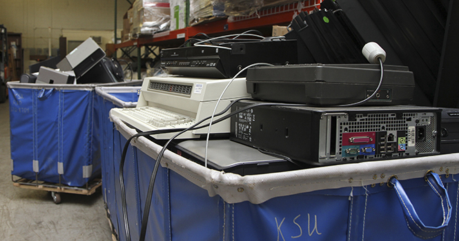 More than 11,000 pounds of electronic waste, including computers, phones and gaming consoles, collected during RecycleMania await disposal at the University Facilities Management store room on Summit Street on Wednesday, April 17. Photo by Shane Flanigan.