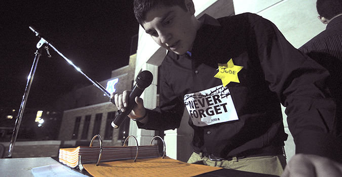 Michael Pollak, freshman business management major, reads names around 11 p.m. Sunday, April 7. Photo by Jacob Byk.