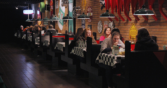 Kent State students eat at the on campus Quaker Steak and Lube on Tuesday, March 19. Quaker Steak, on the first floor of the student center, is one of the several different options students have for on campus dining. Photo by Melanie nesteruk.