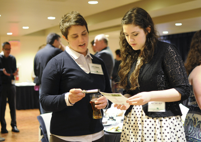 Kate Common, one of the founding members of Fusion, reviews her speech notes with current staff member Brittany Rees at the Fusion 10th Anniversary Gala on Saturday, April 13. The gala was held in the student center balcony ballroom and invited current staff members and alumni to join for an evening of dinner and speakers. Photo by Meg Billy.