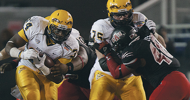 Sophmore runningback Trayion Durham breaks through Arkansas State's defensiveline during the 2013 GoDaddy.Com Bowl in Mobile Alabama, on January 6. Kent State was unable to beat Arkansas State losing the bowl game 13-17. Photo by Coty Giannelli.