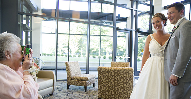 Sadie Kelly (left) shares a nice moment with friends and family members. Sadie Kelly and Nathan Sargent were married at the Kent State University Hotel on July 26, 2013. Photo by Yolanda Li.