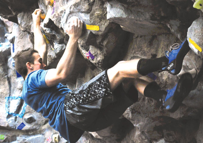 Andy Hanson, exercise science major at the University of Akron, tackles one of the hardest routes during a bouldering competition at the Kent State Rec center. Hanson said he enjoyed bouldering because it was something new and exciting to do. Photo by Rachael Le Goubin