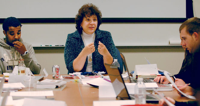 jan Leach talks with her students during her Newswriting class on Jan. 24. "It's just fun to see the way they grasp a concept or the way they apply things,"Leach said. "It's just energizing to me." Photo by Nancy Urchak