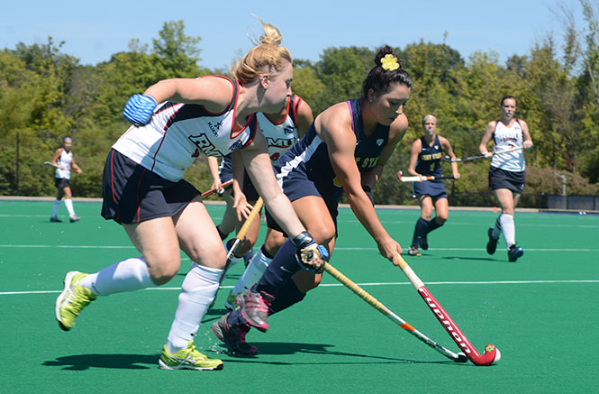 Kent State senior Rebecca Lee (right) rushes towards the goal during an exhibition game against Robert Morrison August 23. Kent State edged Robert Morrison, 9-6. Photo by Melanie Nesteruk.