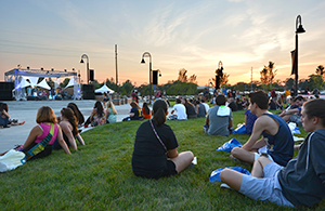 Students listen to live music at sunset on the Student Green during Blastoff, where student organizations congregated to spark interest and recruit new students on Aug. 25, 2013.