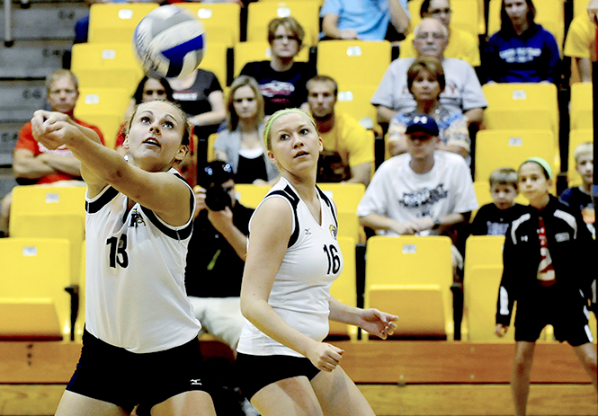 Kent State senior Kathy Krupa (left) bumps the ball over the net during the Flashes' game against Liberty September 5, 2012. Photo by Hannah Potes.