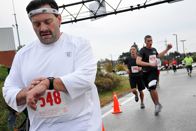 Participant Ralph Reafer stops his timer after finishing the Bowman Cup 5k Saturday, Oct. 15, 2011. This year's Bowman Cup 5K will be held this Saturday, Oct. 5, 2013 at 8 a.m. Photo by Megann Galehouse.