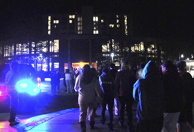 Students file back into the Rottunda of Tri-Towers after a hand sanitizer dispenser caught fire on the eighth floor of Koonce Hall, requiring students to evacuate around 3 a.m. February 8, 2013. Drills are held regularly to ensure students' safety in case of emergencies such as this.. Photo by Jessica Denton.