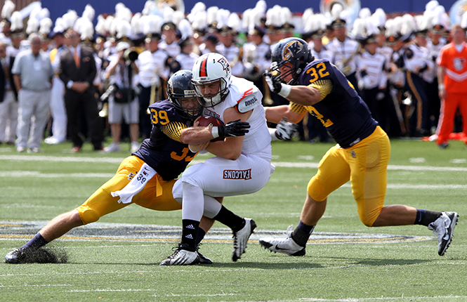 Kent State senior safety Luke Wollet (left) and sophmore left back Matt Dellinger (right) sack Bowling Green quarterback Matt Johnson during Saturday's game on Sept. 7, 2013. Kent State lost to Bowling Green 41-22. Photo by Melanie Nesteruk.