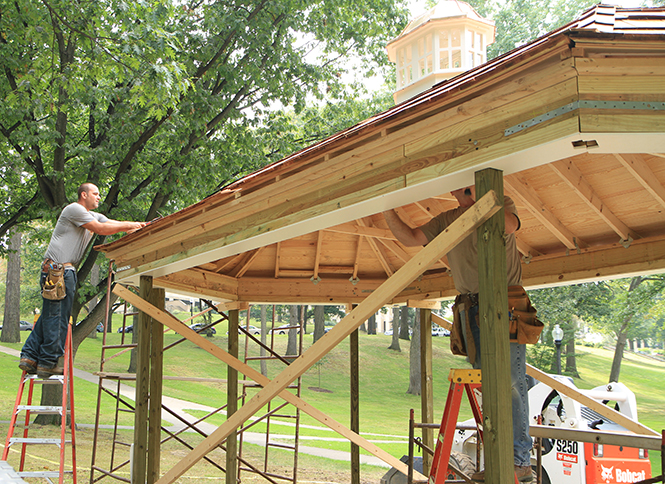 Carpenter Darrin Waselich (left) and Greg Renicker (right) works on the new gazebo by the rock, on Thursday September 19, 2013. Photo by Yolanda Li.