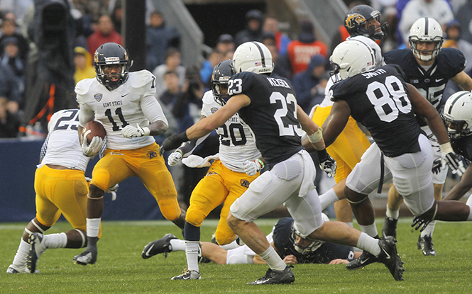 Kent State wide receiver James Brook tries to avoid being tackled by the Penn State defensive line during Saturday's game. Kent State lost the game to Penn State 34-0. Photo by Melanie Nesteruk.