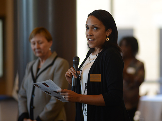 Kate McAnulty, Ph.D. of Graduate Studies, reads the names of Graduate Dean's Awards recipients clapped during Cartright Hall's reception on Sept. 26. Photo by Jacob Byk.