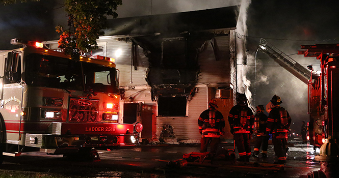 The bar Checkers N Trophies on the corner of West Elm and Pine Street suffered from a fire that started Monday evening. The fire drew at least four departments along with Kent City fire and police. Photo by Brian Smith.