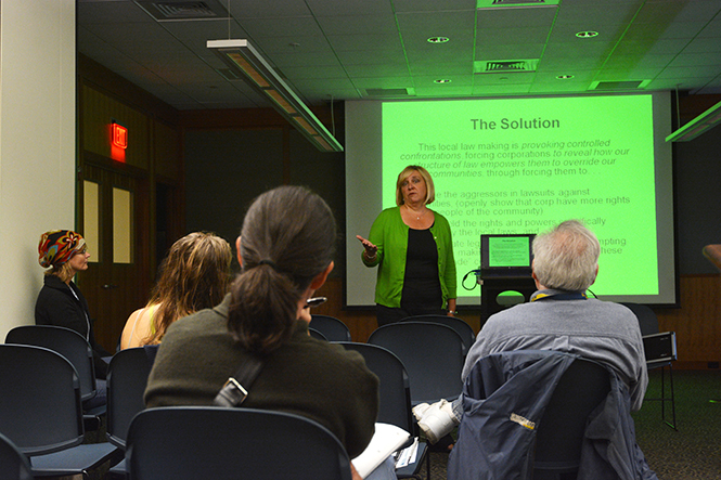 Tish O'Dell, the Ohio organizer for CELDF, Community Environmental Legal Defense Fund, speaks to a group of 20 people in the Kent Free Library about environmental issues such as fracking, on Sept. 22. Photo by Jacob Byk.