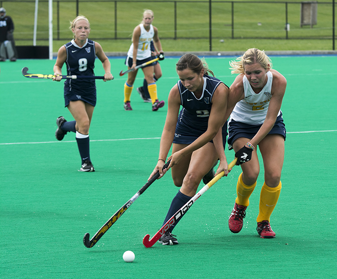 Sabrina Binder tries to get the puck back from Villanova opponent on Sept. 15; 2013. Kent State won the game 4-1. Photo by Abby Schafer.