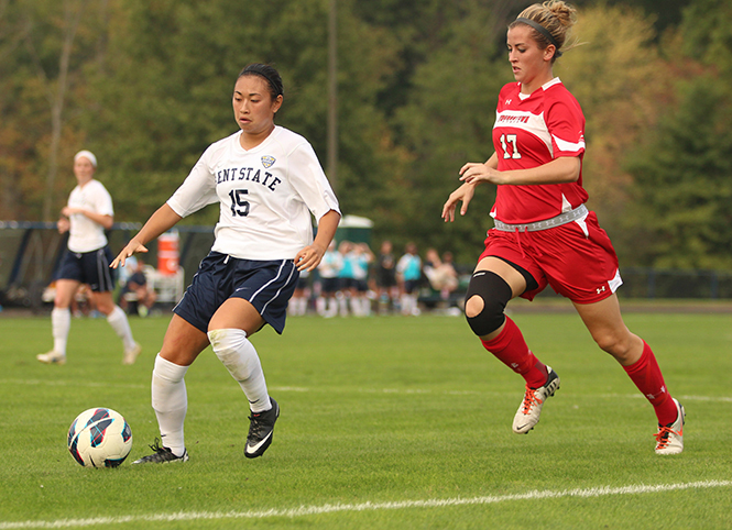 Kent State's Morgan Mah leads with the ball as Youngstown State University's Taylor Ross follows behind on Friday Sept. 20, 2013. Kent State defeated Youngstown 3-0. Photo by Eslah Attar .