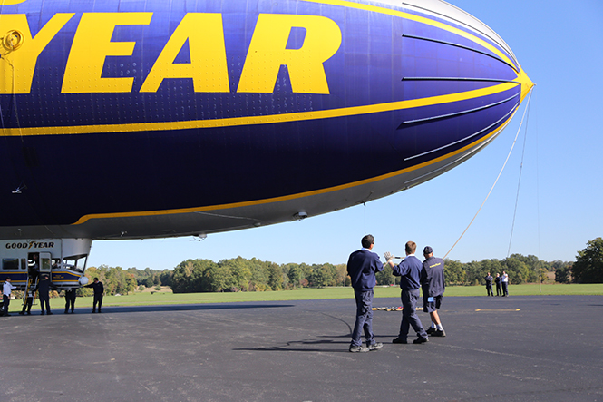 Ground crew members of the "Spirit of Goodyear" help steady the blimp after it landed in Suffield Township on Wednesday, Oct. 9, 2013. Photo by Brian Smith.