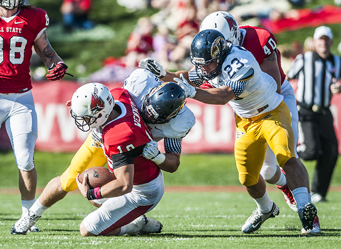 Ball State University's senior quarterback Keith Wenning is brought down after a run attempt against Kent State. Photo by Jonathan Miksanek, Ball State Daily News.