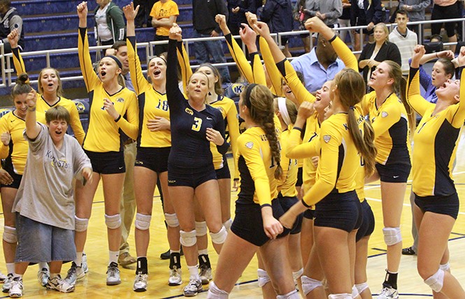 The Kent State volleyball team celebrates their win again Ohio University, on Thursday on October 10, 2013. Kent State won the match against Ohio University, 3-1. Photo by Elena Rounsley.