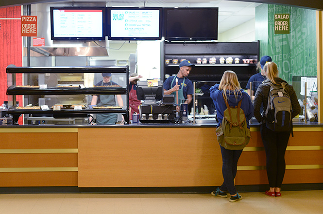 Kent State students order salads, a healthier option, at "The Slice" in the Hub on Thursday evening, Oct. 16, 2013. Photo by Melanie Nesteruk.