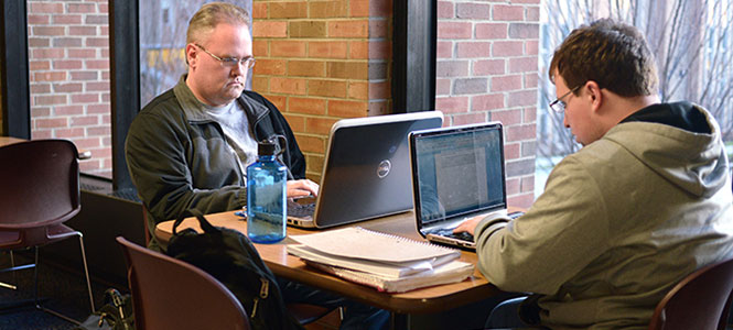 Kent State senior chemistry major Matthew Davis sits with senior Justin Robinson on the second floor of the student center. Davis is one of many nontraditional students attending Kent State. "I tried going to college after high school, but I wasn't ready," Davis said. Photo by Melanie Nesteruk.