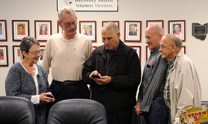 Alberta Caetta, Bill Nome, Dennis Missimi, Joel Mowrey, Gene Mills gather around to view the updated results on Issue 3 at the Mental Health &amp; Recovery Board of Portage County on Tuesday, Nov. 5, 2013. Photo by Rachael Le Goubin