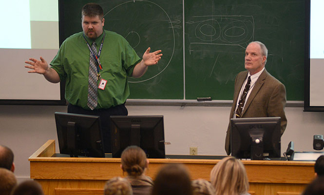 (From left) Assistant air traffic control professor Jason Boergerhoff and assistant flight and air traffic control professor Robert Priestley speak to students of the Kent State aeronautics program about the recent changes made by the Federal Aviation Administration to the air traffic control hiring process, in Van Deusen Hall, Thursday, Jan. 23, 2014. The new process will no longer take applicants' job location preference into account when hiring, announced Jan. 10, 2014.