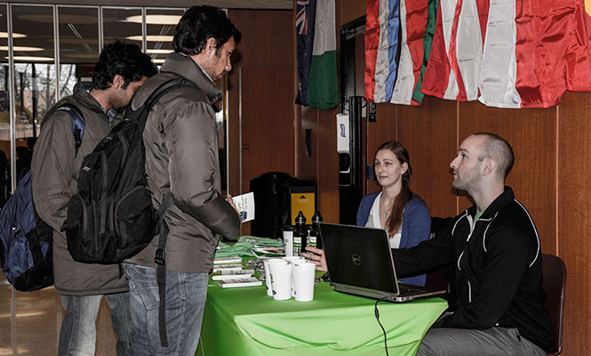 Computer Science major Uday Avinash asks Zipcar representative Alex Abramo about the new service. Zipcar will allow all students, including International students, to rent cars from campus.