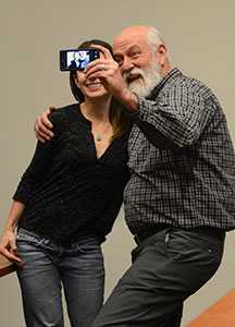  David LaBelle, director of the department of photojournalism, and photographer-filmmaker Maisie Crow smile for a picture together after Crow's lecture and film showing for the school of journalism and communication at Franklin Hall, Thursday evening, Jan. 30, 2014.