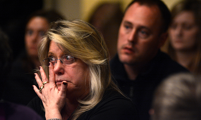 Donna Piszko, a Chardon resident of 15 years, wipes a tear away while listening to Principal DeAngelis speak about unity in communities that have experienced school shootings. "You always have a home with Columbine High School", he said about Chardon High School.