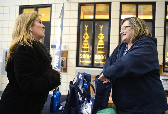  Kent State staff ombudsman Karen Watson gives a ticket and door prizes to College of Nursing employee at the men's basketball against Buffalo, Saturday, Feb. 22, 2014, on Employee Appreciation Day. The human resources department gave away around 400 hundred tickets to Kent State faculty as a token of appreciation.