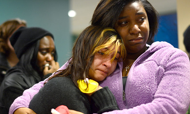 Anna Saez (left), freshman art history major sobs while clutching Lexi Lewis (right), freshman nursing major, during the dedication of the art studio in Verder Hall to Leah Carothers Wednesday, Feb. 13, 2014. Carothers passed away in late November.