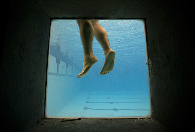 A Kent State Air Force cadet waits in the water for a fellow cadet to walk off the high dive blindfolded as a part of the Combat Water Survival Training, Sunday morning, Feb. 16, 2014, at the University of Akron's natatorium. During the training they learned survival tactics that are important for use in the military in case of an emergency situation.