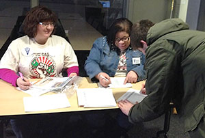 Shannon McDonald (left) and Christina Napier, financial aid counselor at Kent State, assist student Alex Evans at Kent State’s College Goal Sunday in Franklin Hall, Sunday Feb. 9, 2014.