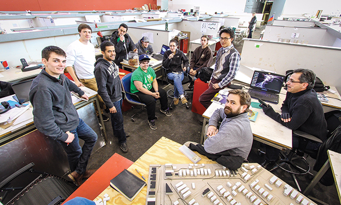 Professor Chris Maurer (the second from right) and his students in the third year architecture design studio class pose for a photo after discussing the community engagement for their renovation project in Cleveland Friday, Feb. 28, 2014.