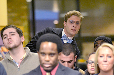 Robert Lierenz stands on a chair to see above the crowd who watch the results of the Undergraduate Student Government election in the student center on Tuesday, Mar. 4, 2014. Lierenz won Director of Governmental affairs by 17 votes.