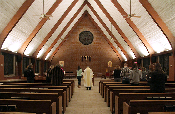 Father Steve Agostino leads a mass at the Newman Center, Thursday, March 13, 2013.