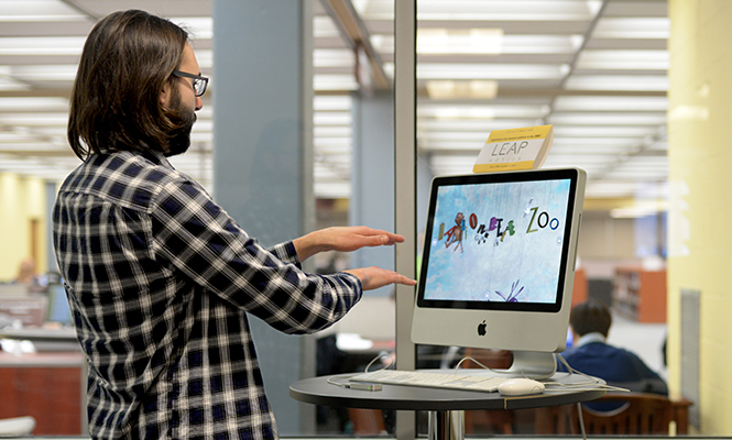 Josh Boord, junior philosophy major and library SMS consultant, demonstrates how to use the new Leap Motion Controller in the multimedia studio of the University Library Sunday, March 16, 2014.