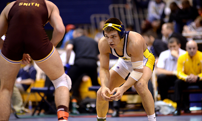 Kent State's Ian Miller prepares for his next move in his final match of the MAC Championship Sunday, March 9, 2014. Miller defeated his opponent from Central Michigan and finished first in his weight class, winning him a Mid-American Conference title.