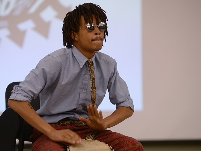 Pan-African studies senior Damien McClendon presents his piece "Theres a Railroad at the Bottom of the Atlantic Ocean Made of Human Bones" at the 3rd semi-annual "Under The Baobab Tree" talent showcase Thursday, April 10, 2014.